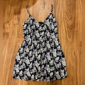Navy blue romper with white flowers and leaves